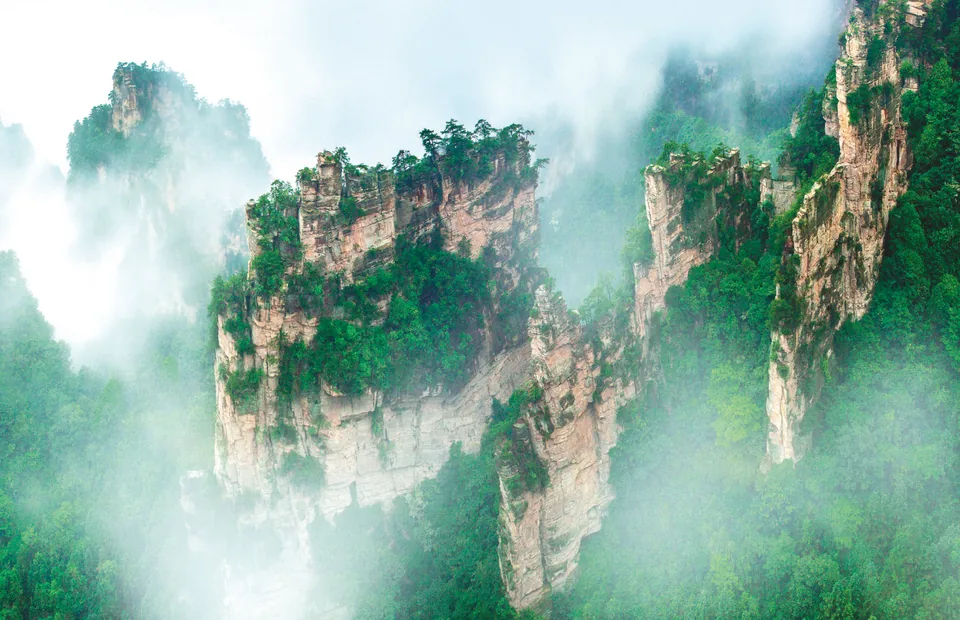 Layered sandstone walls extending across Yangjiajie