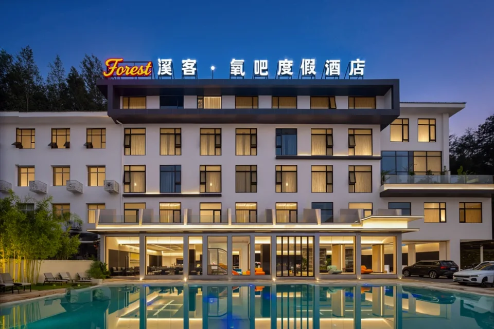 Forest Xike Hotel exterior and swimming pool at dusk