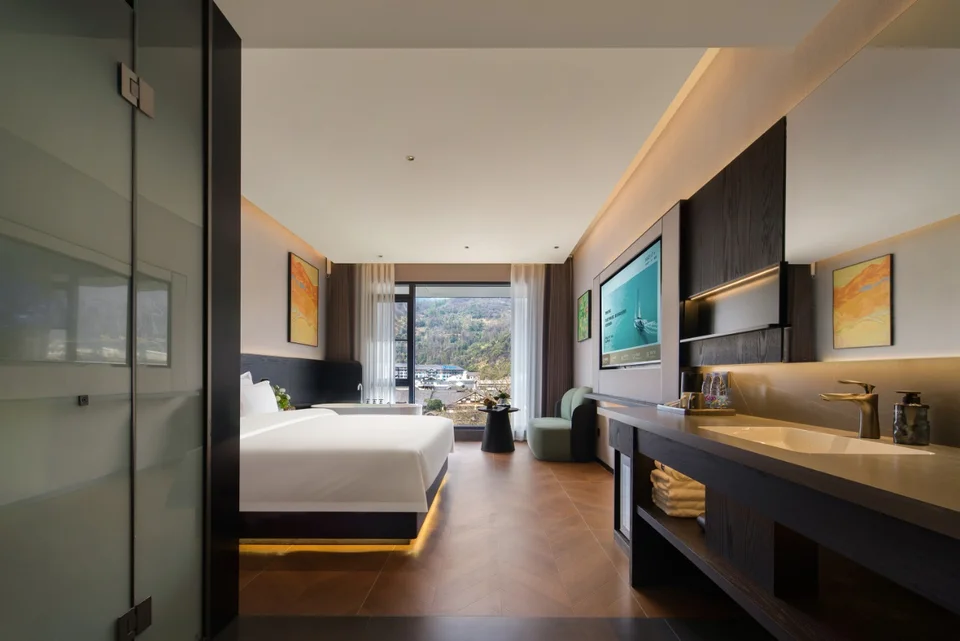 Guest room and window-side seating at Forest Xike Hotel