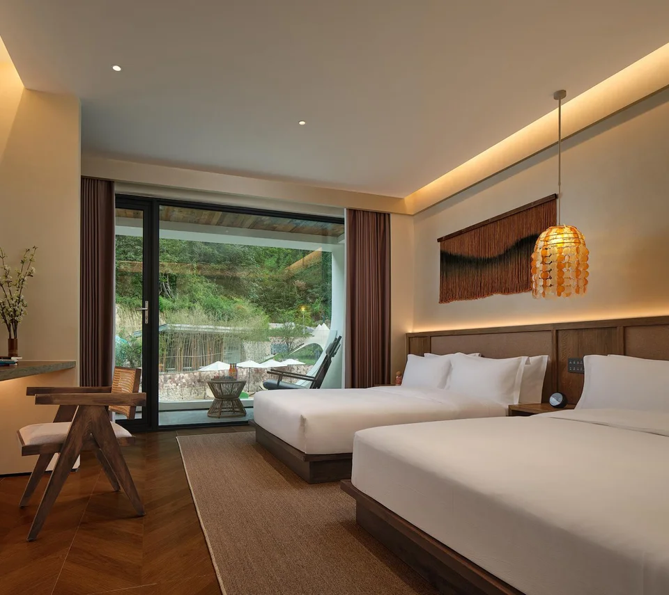 Twin beds and window view in a suite
