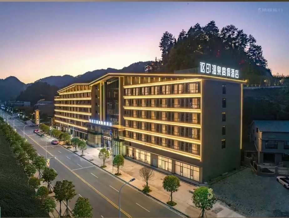 Fenghuang Ouyin Hot Spring Resort Hotel exterior at dusk