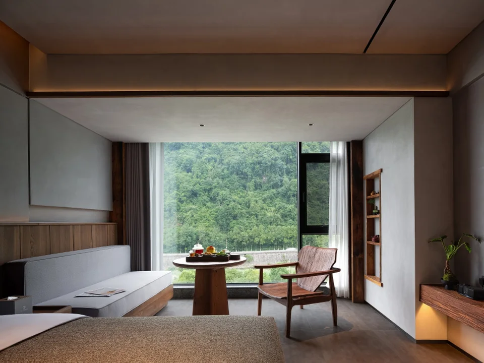 Window-side tea table and mountain view in a room at Sanhe Tea Space Resort Hotel