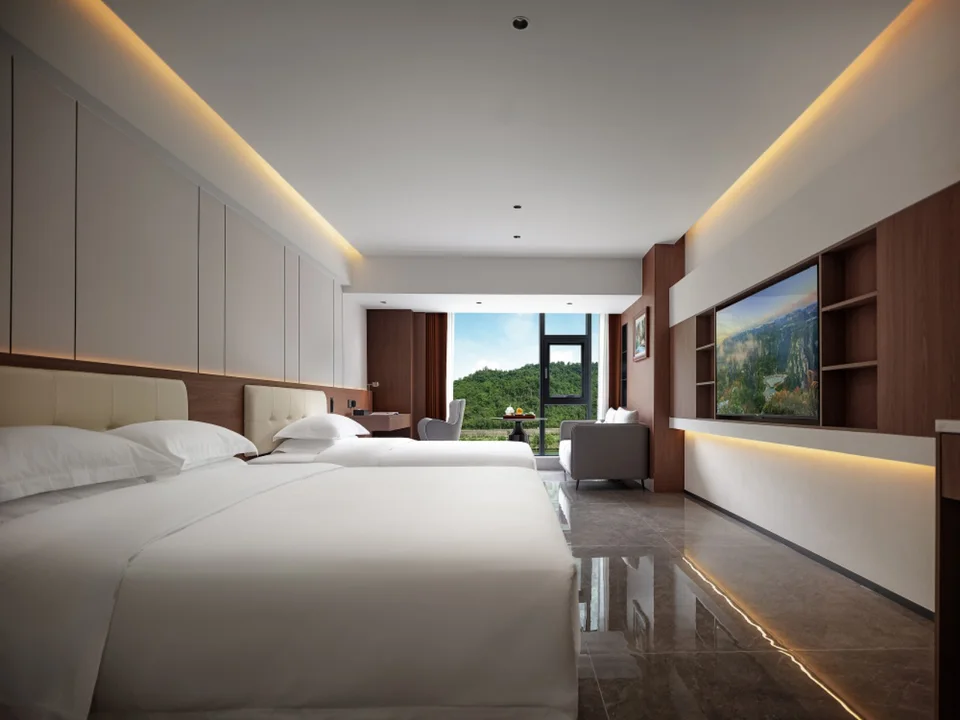 Twin room with window-side seating at Sanhe Tea Space Resort Hotel