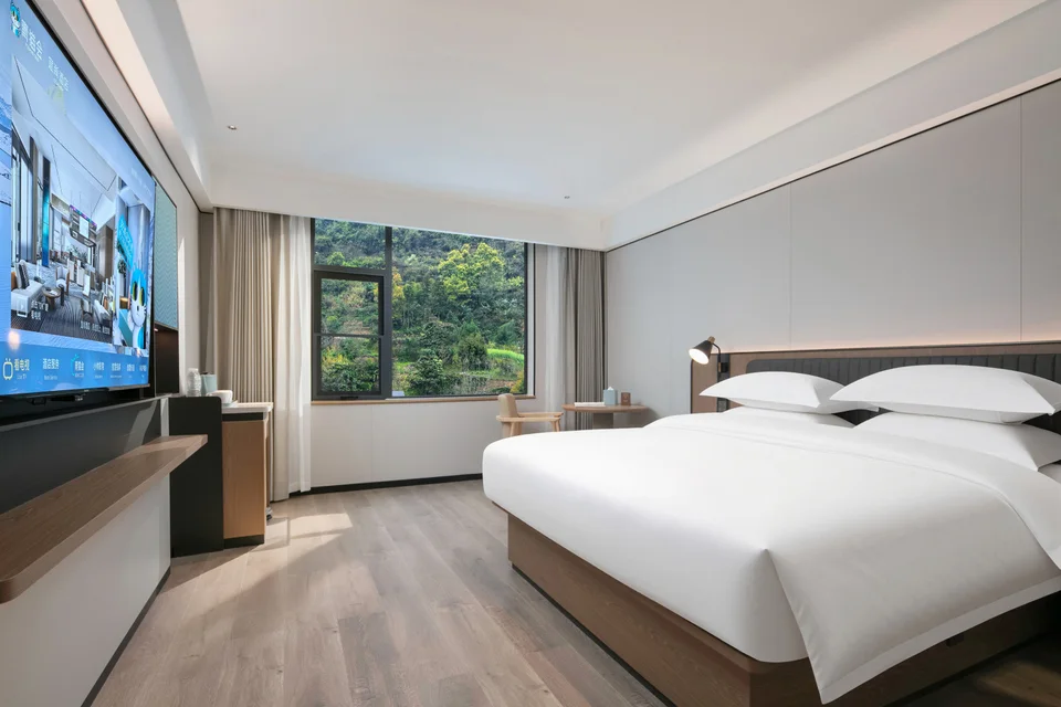 Double room and window-side seating at Echarm Hotel