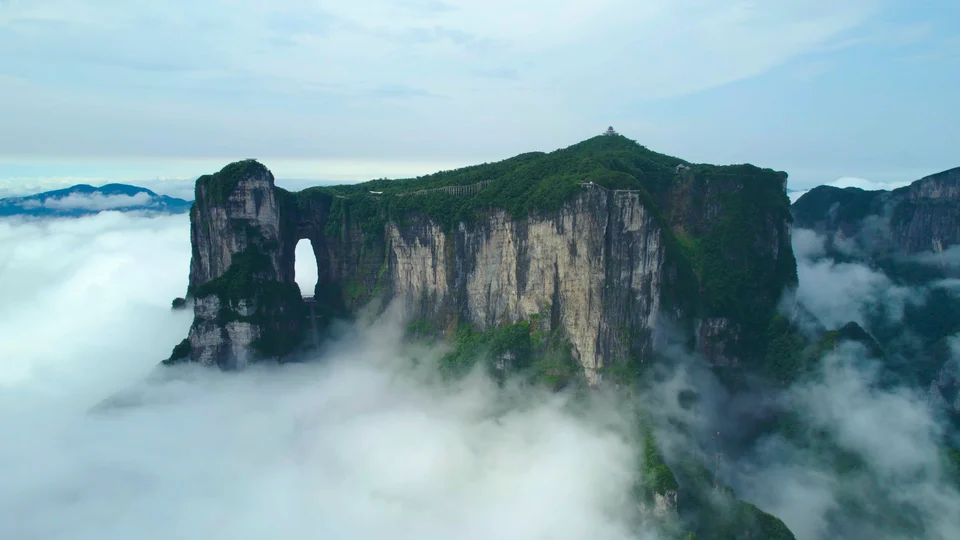 Panorama of Tianmen Mountain and Tianmen Cave amid clouds