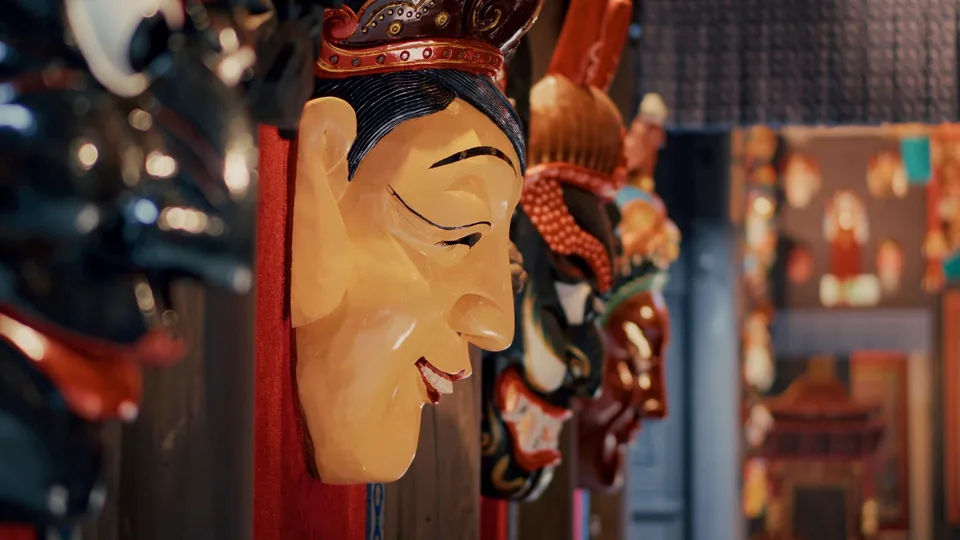 Side detail of a painted mask at Xiangxi Fu